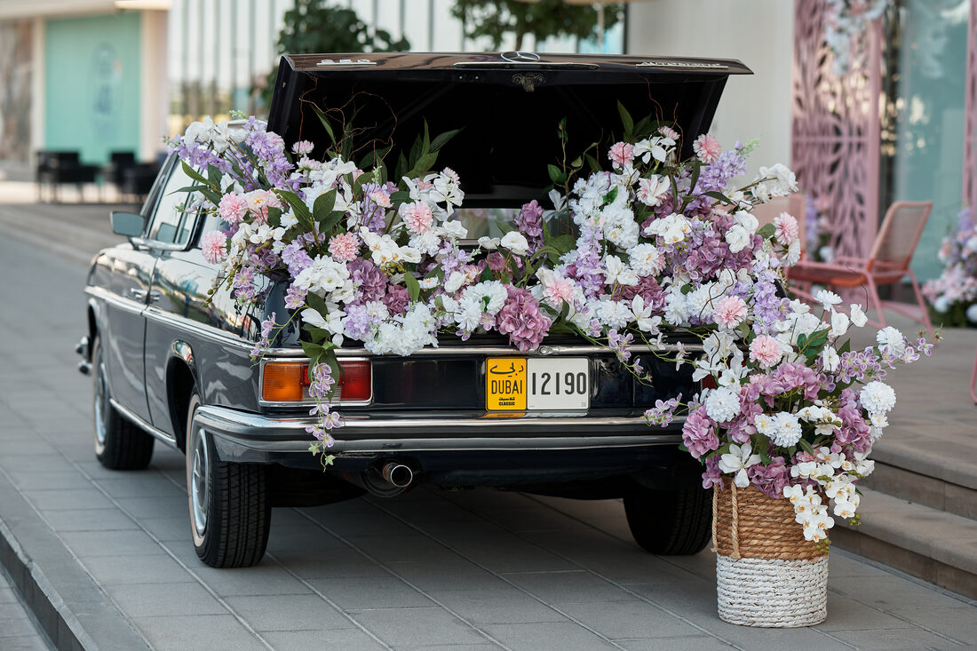 Flower Corner's classic wedding car dressed with fresh flowers