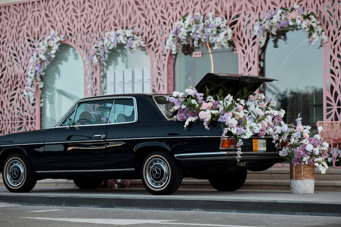 Flower Corner's classic wedding car dressed with fresh flowers