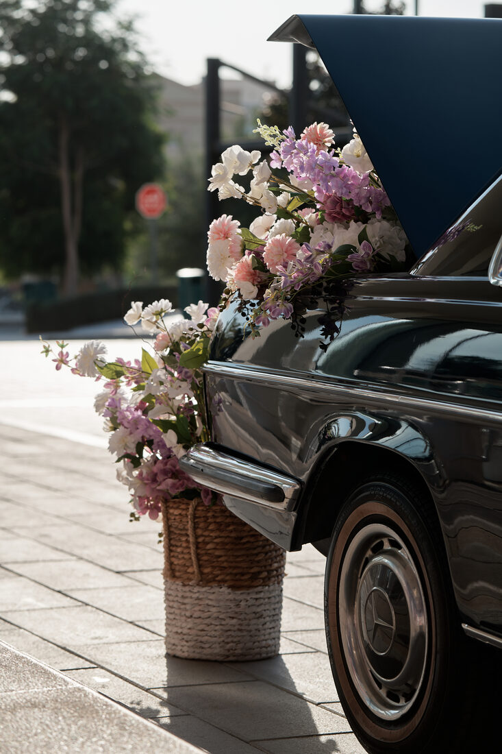Flower Corner's classic wedding car dressed with fresh flowers